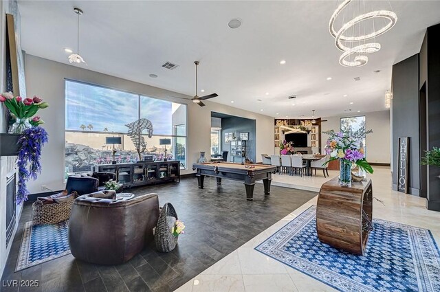 recreation room featuring ceiling fan with notable chandelier and pool table