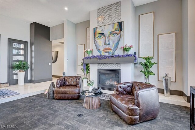 sitting room featuring a tile fireplace