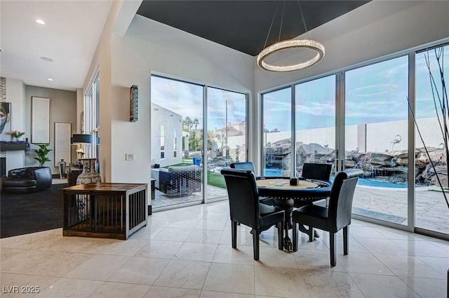 dining area featuring light tile patterned flooring and a healthy amount of sunlight