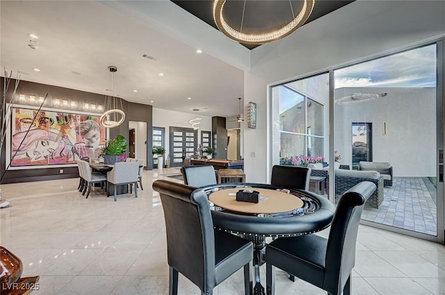 dining room featuring an inviting chandelier and plenty of natural light