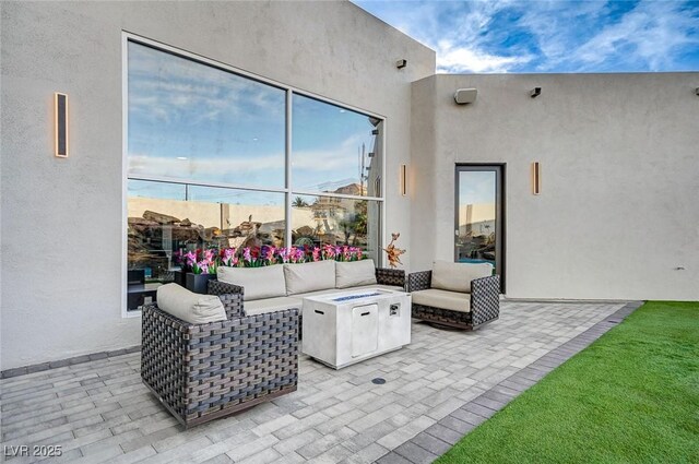 view of patio / terrace with an outdoor living space with a fire pit