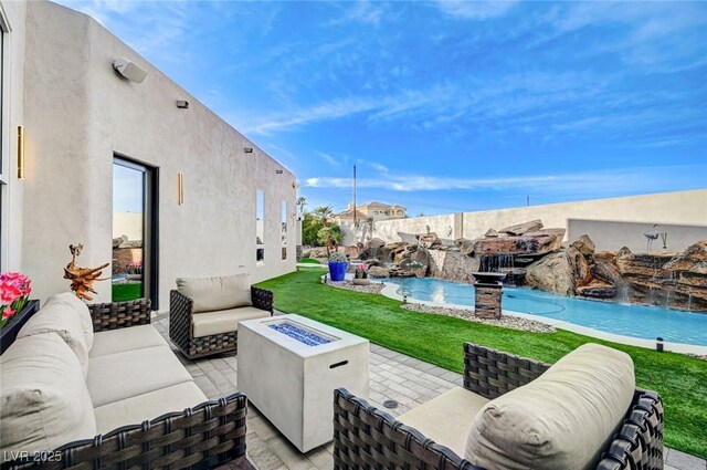 view of patio / terrace featuring an outdoor living space with a fire pit and pool water feature