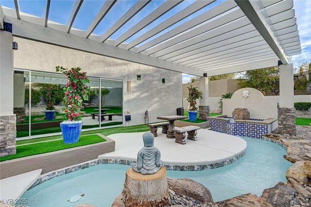 view of pool featuring a pergola, an outdoor stone fireplace, and a patio area