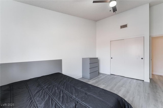 unfurnished bedroom with a closet, ceiling fan, and light hardwood / wood-style flooring