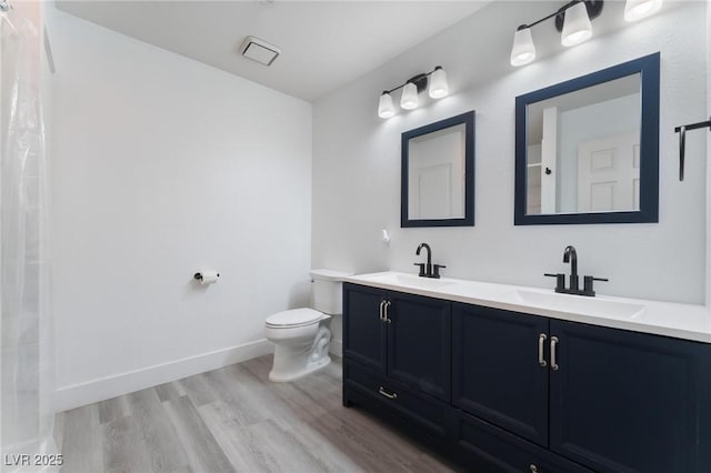 bathroom featuring toilet, hardwood / wood-style flooring, and vanity