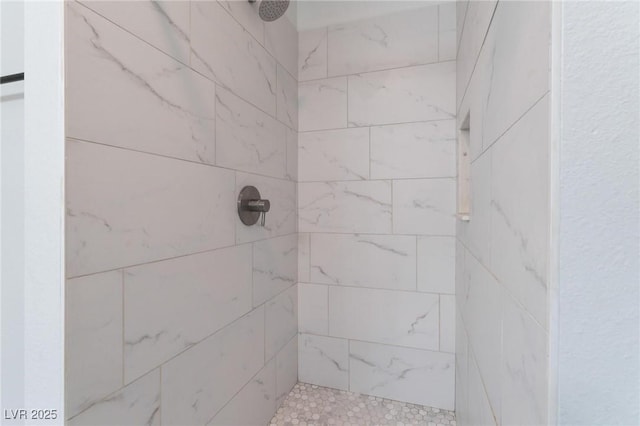 bathroom with tiled shower