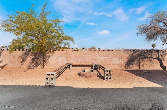 view of yard with a fire pit