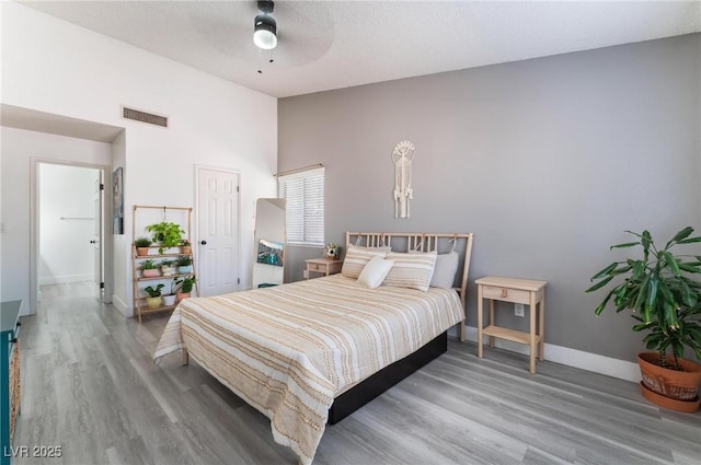 bedroom with wood-type flooring, a textured ceiling, and ceiling fan