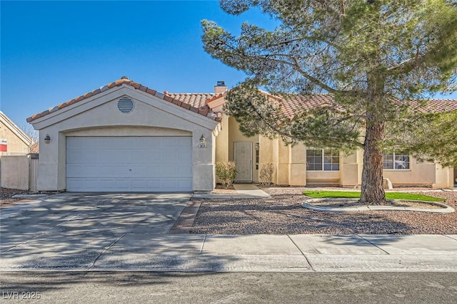 mediterranean / spanish-style home with stucco siding, a garage, concrete driveway, and a tiled roof