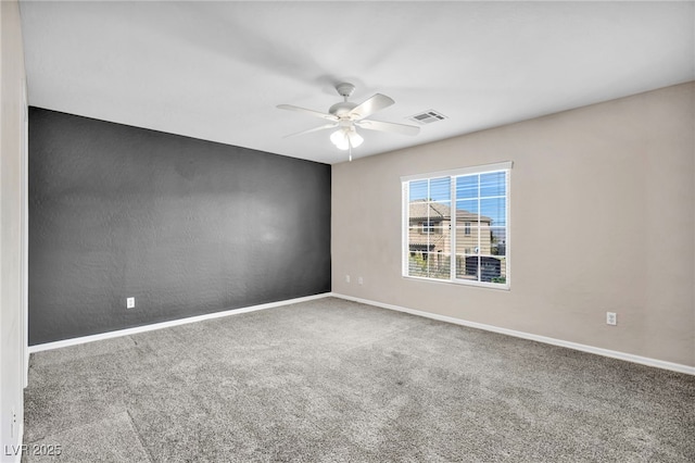 empty room featuring ceiling fan and carpet floors