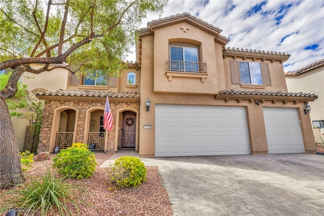 mediterranean / spanish-style home with a garage