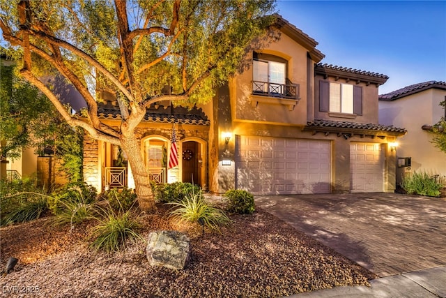 mediterranean / spanish home featuring a garage