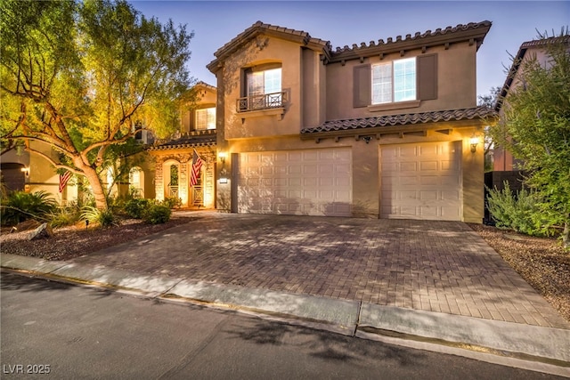 mediterranean / spanish home with a garage