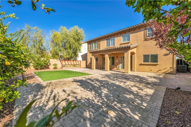 rear view of house with cooling unit and a patio area