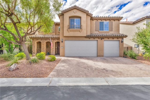 mediterranean / spanish-style home with a garage