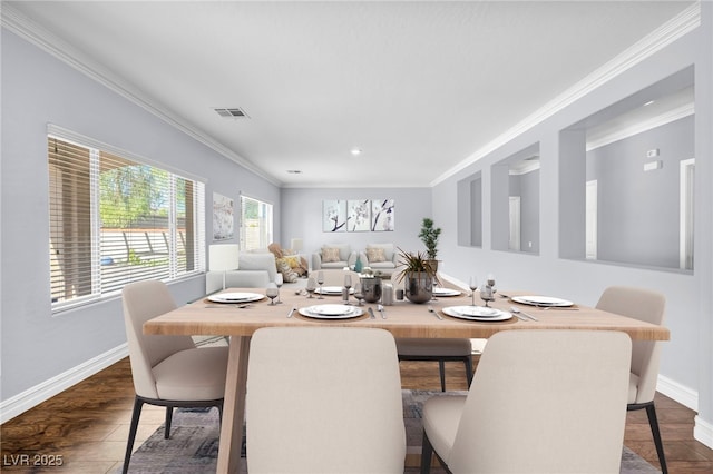 dining area with crown molding and dark wood-type flooring