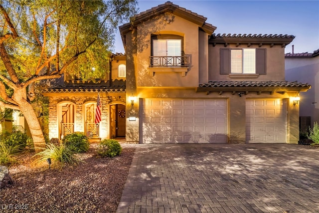 mediterranean / spanish-style home featuring a garage