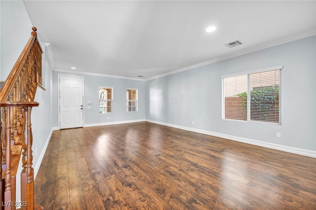 unfurnished living room featuring crown molding and dark wood-type flooring