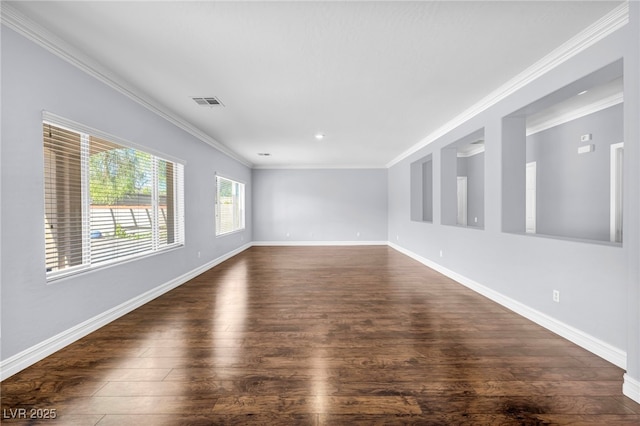 empty room with crown molding and dark wood-type flooring