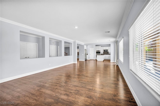 unfurnished living room with dark wood-type flooring and crown molding