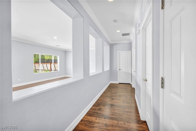 hall with ornamental molding and dark wood-type flooring