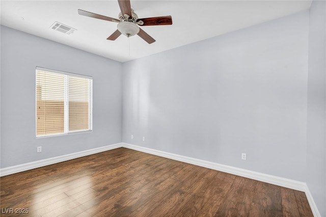 spare room featuring ceiling fan and dark hardwood / wood-style floors