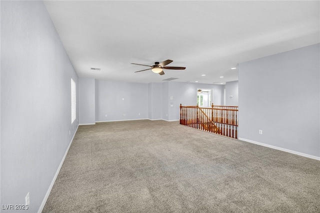 spare room featuring ceiling fan and carpet flooring