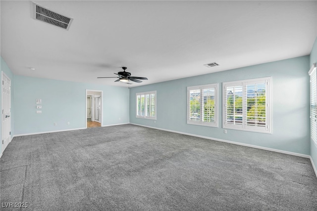 carpeted spare room featuring ceiling fan