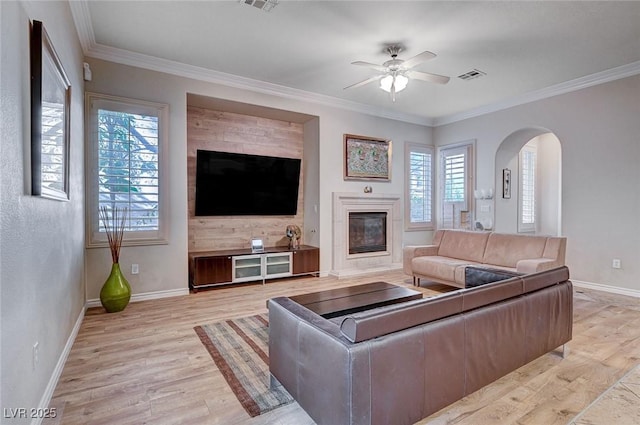 living room with ceiling fan, light hardwood / wood-style flooring, and crown molding