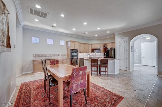 dining room featuring ornamental molding and light tile patterned floors