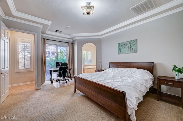 bedroom with ornamental molding and access to exterior