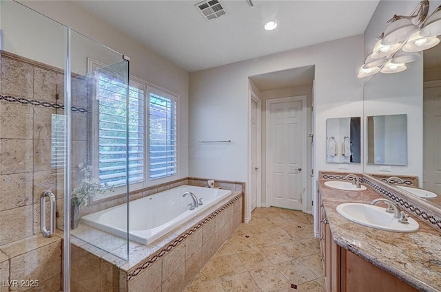 bathroom featuring shower with separate bathtub and vanity