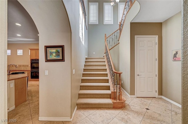 staircase with sink and tile patterned floors