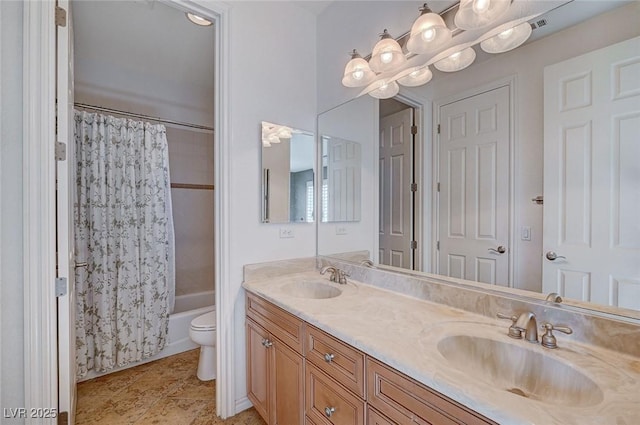 full bathroom featuring vanity, shower / bath combo with shower curtain, and toilet