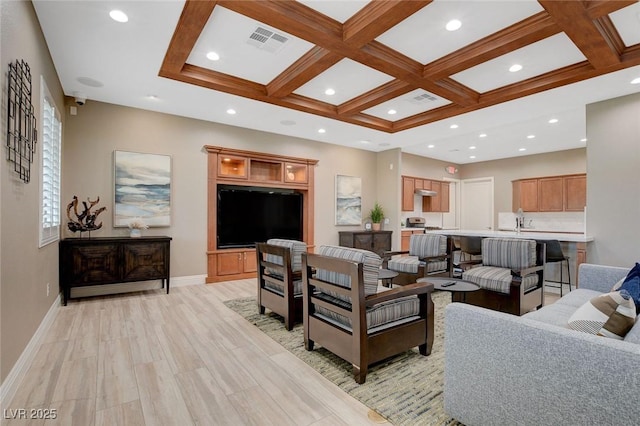 living room featuring beam ceiling, light hardwood / wood-style floors, and coffered ceiling