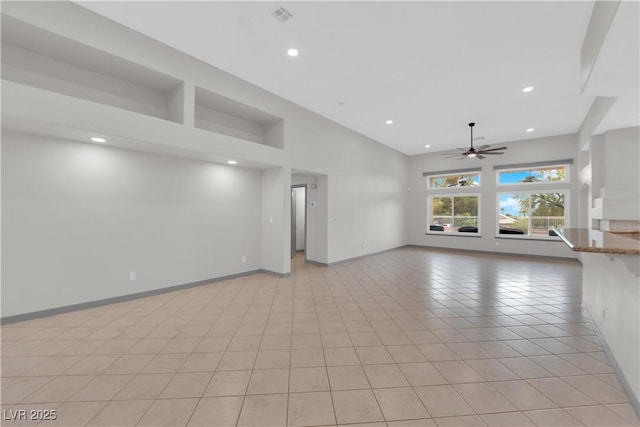 unfurnished living room with ceiling fan and light tile patterned floors