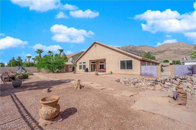 back of house featuring a mountain view and a patio area