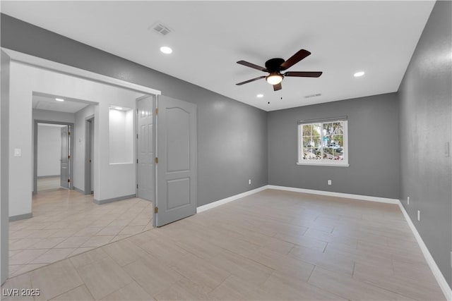 tiled spare room featuring ceiling fan