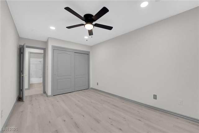 unfurnished bedroom featuring ceiling fan, light hardwood / wood-style flooring, and a closet