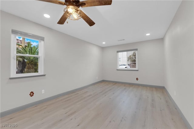 empty room featuring ceiling fan and light hardwood / wood-style flooring