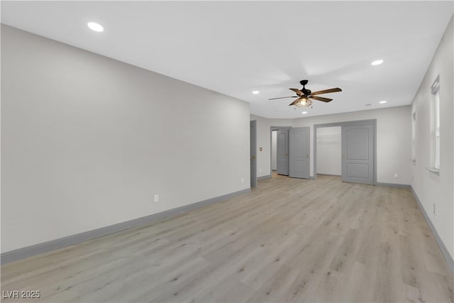 unfurnished bedroom with ceiling fan and light wood-type flooring