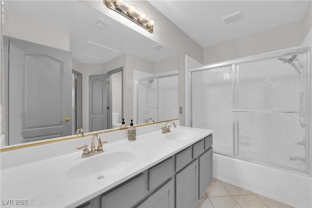 bathroom featuring combined bath / shower with glass door, tile patterned flooring, and vanity