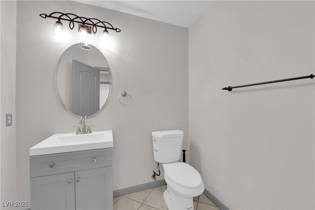 bathroom featuring vanity, tile patterned floors, and toilet