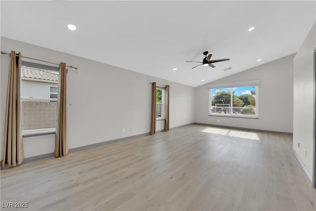 unfurnished room featuring light hardwood / wood-style floors, ceiling fan, and vaulted ceiling