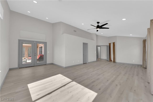 unfurnished living room with ceiling fan, french doors, and light wood-type flooring