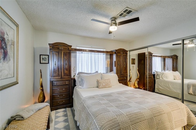 bedroom featuring a closet, ceiling fan, and a textured ceiling