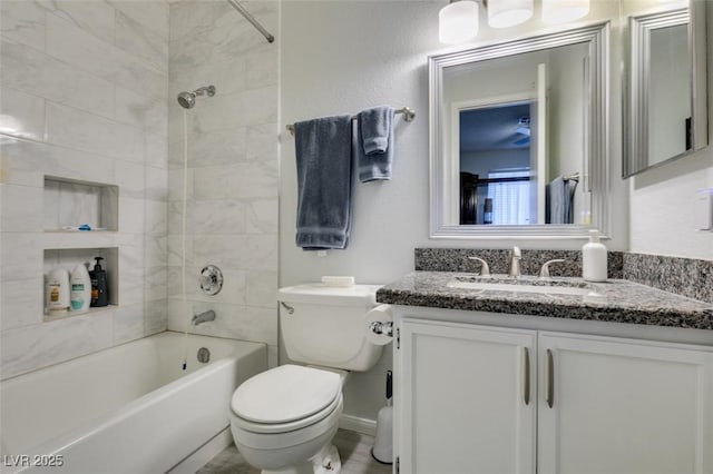 full bathroom featuring toilet, tiled shower / bath combo, and vanity