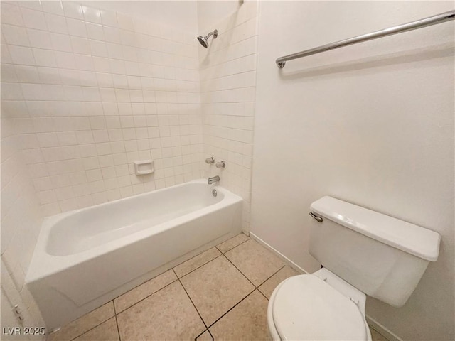 bathroom with toilet, tile patterned floors, and tiled shower / bath