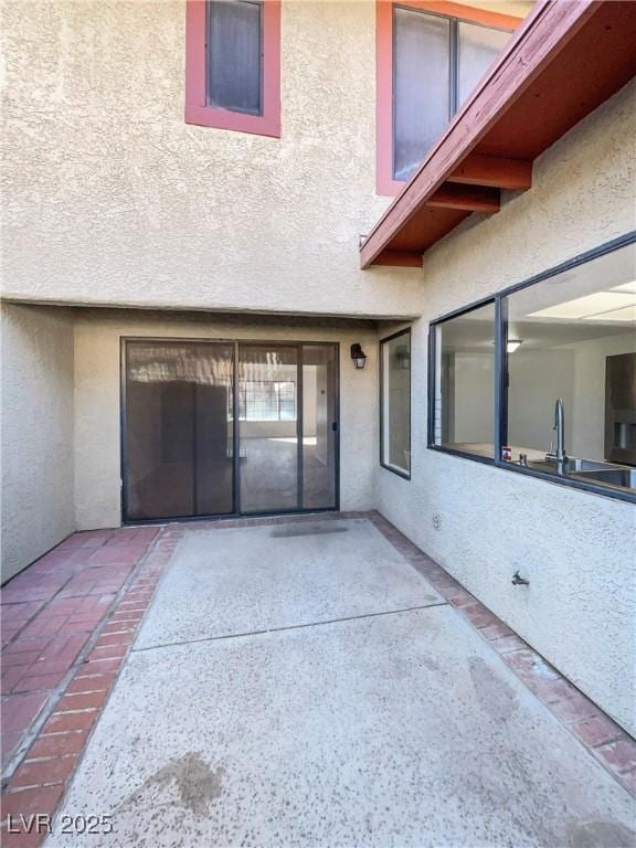 entrance to property with a patio