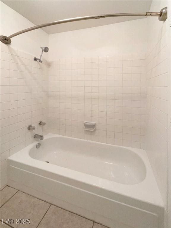 bathroom with tile patterned floors and shower / tub combination